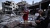 Një familje palestineze duke ngrënë iftarin mes rrënojash, më 11 mars 2024.
