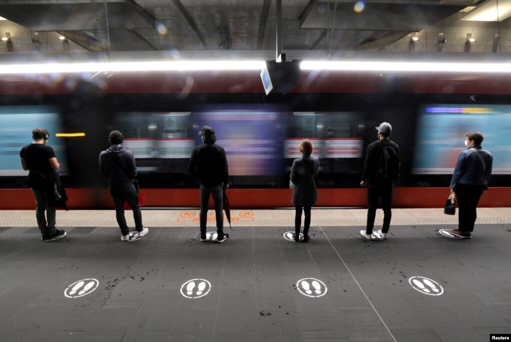 Njerëzit qëndrojnë në vendet e shenjuara për të respektuar distancën sociale në një stacion tramvaji në Nicë, Francë, 11 maj 2020.