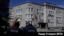 Police monitor a school in Burgas, Bulgaria, that received a bomb threat on March 27.