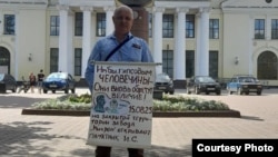 Andrei Ivanov stood in a central town square alone, holding an anti-Stalinist sign bearing lyrics by Soviet bard and dissident poet Aleksandr Galich.