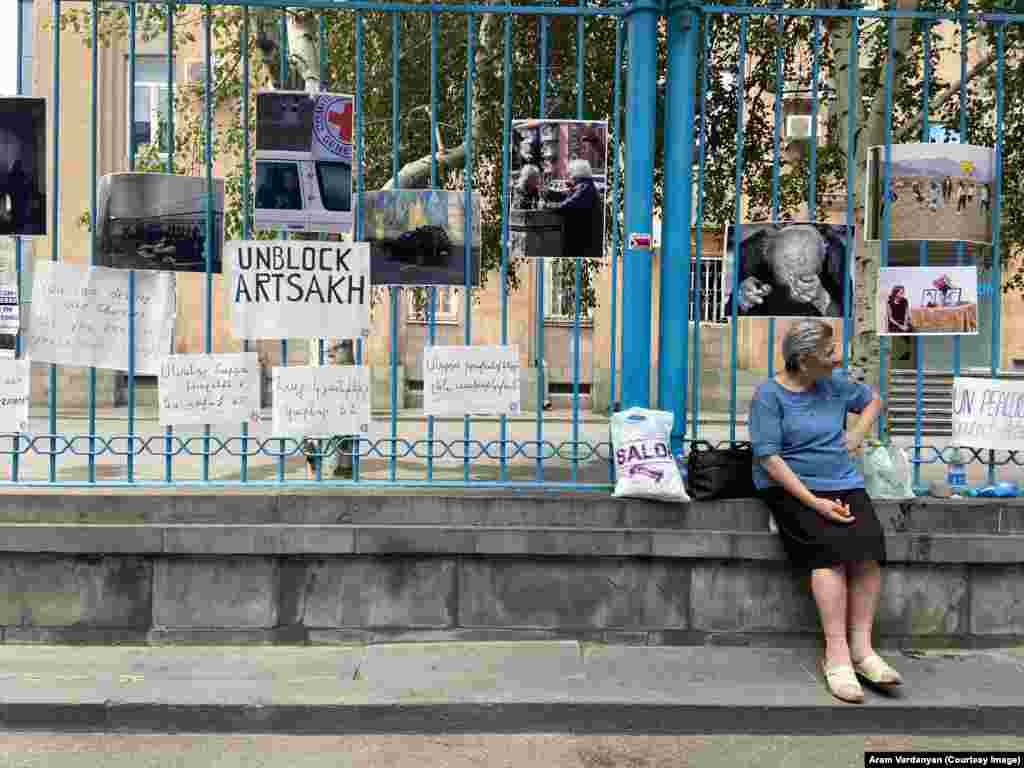 Fencing outside the UN headquarters in Yerevan covered with posters on July 24, including recent images from inside Nagorno-Karabakh, where two children died recently after their single mother left them alone to source food supplies. Armenians refer to Nagorno-Karabakh as Artsakh. &nbsp;