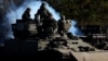 Ukrainian soldiers ride a BREM-1 evacuation tank near the frontline town of Vuhledar in the Donetsk region on March 6.