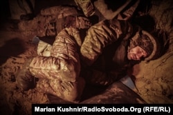 Soldiers of Ukraine's 108th Separate Mountain Assault Battalion rest in a dugout near the village of Synkivka, Kharkiv region, in January.