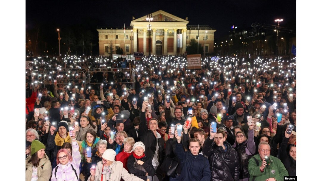 People take part in a demonstration after the resignation of the country's President Katalin Novak and former Justice Minister Judit Varga in Budapest on February 16.
