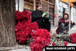 Vendors selling roses wait for customers along Kabul's Flower Street on February 14.