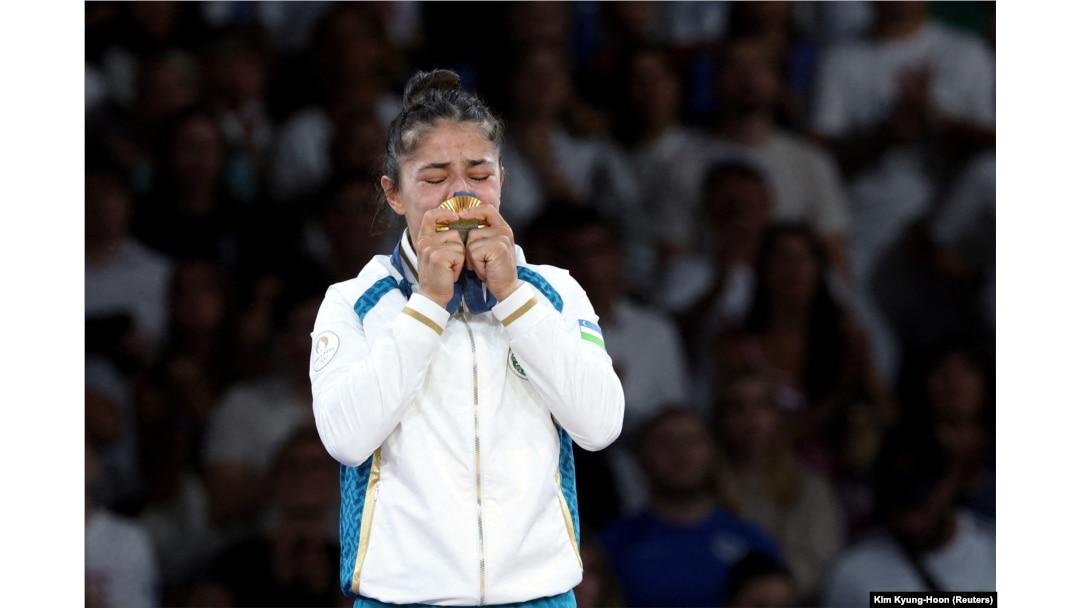 Diyora Keldiyorova of Uzbekistan celebrates on the podium in Paris on July 28.