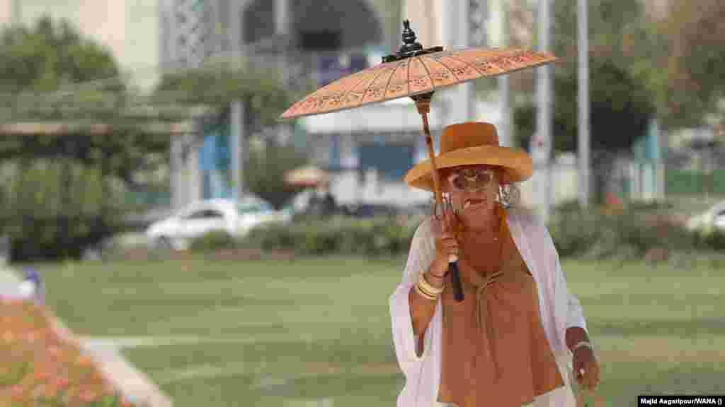 A woman carries a parasol as she tries to stay cool amid an &quot;unprecedented&quot; heat wave in Tehran on August 2. The capital hit 37 degrees Celsius, while other parts of the country saw temperatures hit 40 degrees. The extreme heat comes as rising anger over a range of economic issues as well as water outages has led to&nbsp;protests against the government&#39;s mismanagement of resources. &nbsp;