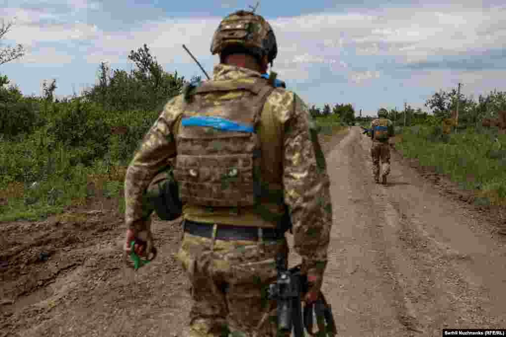 Ukrainian soldiers walk along a road in the liberated village of Novodarivka. The village was liberated on June 4 as part of Kyiv&#39;s counteroffensive that began after it accumulated stockpiles of Western arms and ammunition.