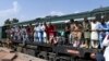 Passengers board a train at a railway station in Lahore on April 20 as they travel back home ahead of the Eid al-Fitr festival marking the end of the holy fasting month of Ramadan. 