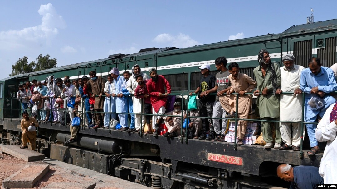 Passengers board a train at a railway station in Lahore on April 20 as they travel back home ahead of the Eid al-Fitr festival marking the end of the holy fasting month of Ramadan.