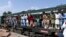 Passengers board a train at a railway station in Lahore on April 20 as they travel back home ahead of the Eid al-Fitr festival marking the end of the holy fasting month of Ramadan. 
