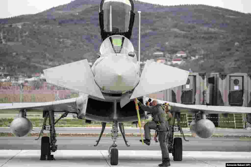 A pilot steps down from his Italian Eurofighter Typhoon after landing during the inauguration ceremony. &nbsp;