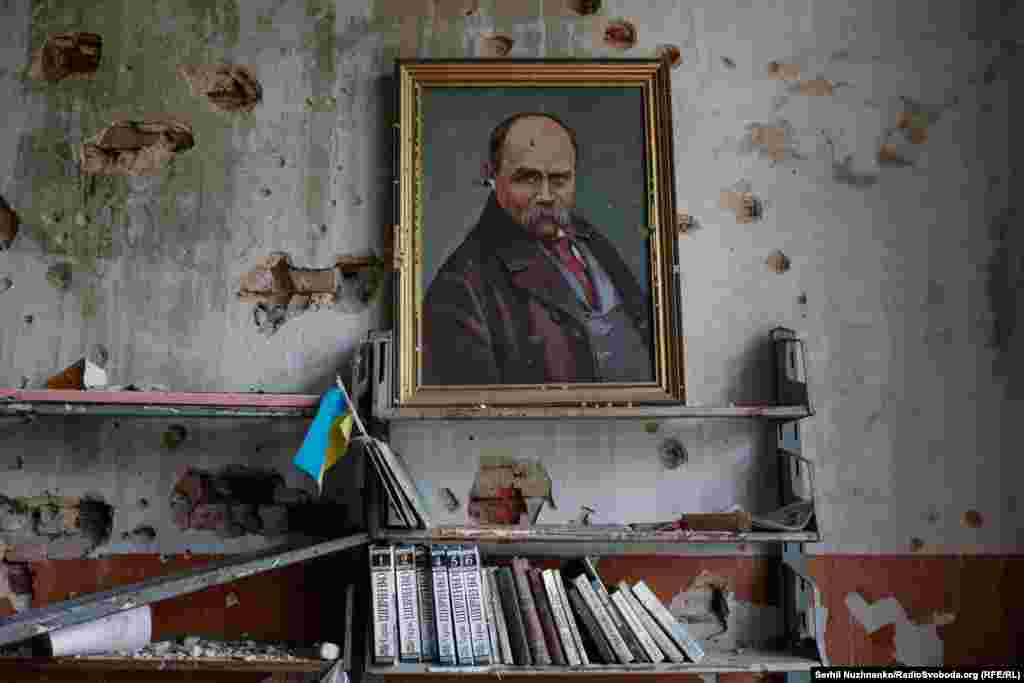 A framed painting of the Ukrainian poet, writer, and political figure Taras Shevchenko is surrounded by bullet holes in the library of Blahodatne&#39;s&nbsp;House of Culture. &nbsp;