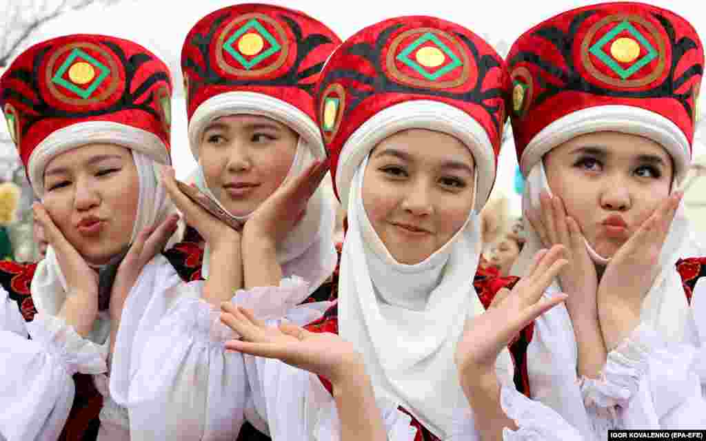 Kyrgyz girls pose in traditional costumes during a Norouz celebration in Bishkek.