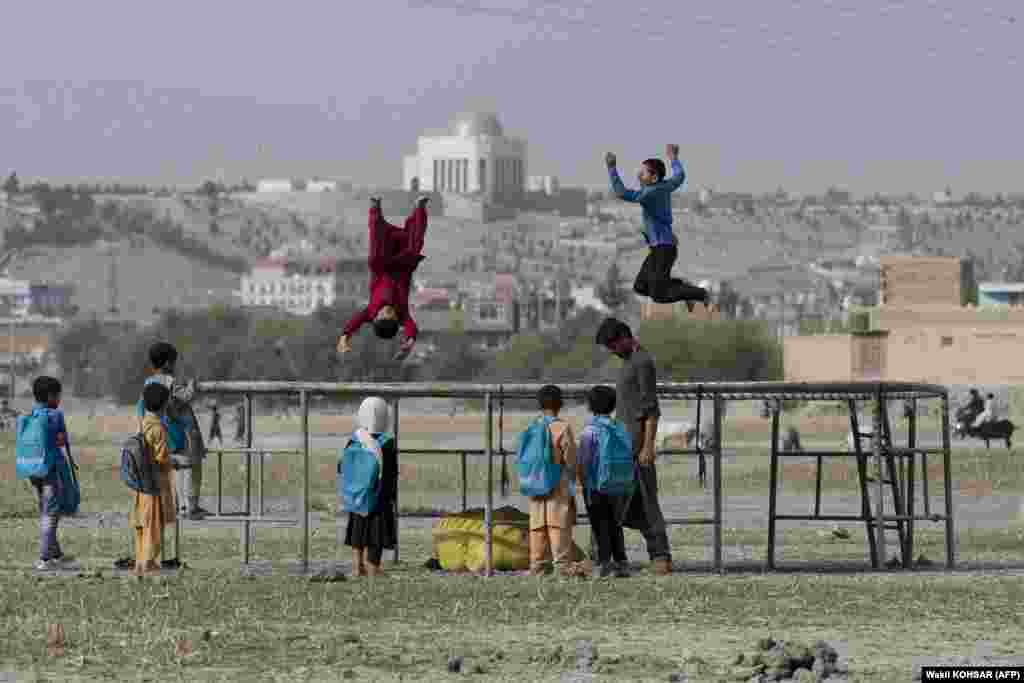 Afghan boys jump on a trampoline at Shuhada Lake in Kabul.&nbsp;