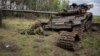 The body of a Russian soldier is seen near a destroyed Russian tank in the village of Storozheve in the Donetsk region on June 14.