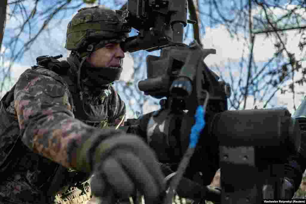 A member of the artillery brigade zeros in on Russian positions... &nbsp;