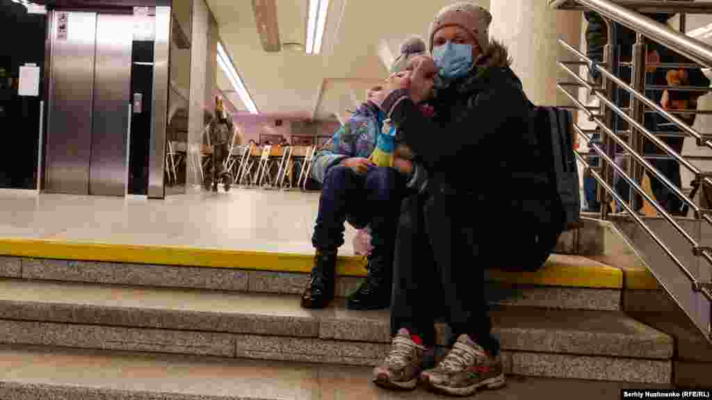 A woman hugs her child in a subway station in Kyiv during a possible Russian air strike on the first day of the Russian assault -- February 24, 2022.