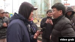 Нефтяник из Жанаозена (слева) и представитель «КазМунайГаза» во время спора на улице. Рабочие требуют вести переговоры с заполнением протоколов и последующей их выдачей. Астана, 14 апреля 2023 года