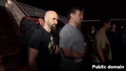 Pablo Gonzalez (left), an alleged Russian spy also known as Pavel Rubtsov, disembarking from a plane in Russia on August 1 after arriving with other Russians released in a historic prisoner swap with the West. The group was greeted on the tarmac by Russian President Vladimir Putin.