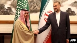 Iran's Foreign Minister Hossein Amir-Abdollahian (right) and Saudi Foreign Minister Prince Faisal bin Farhan shake hands in Beijing on April 6.