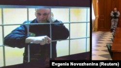 Aleksei Navalny is seen on a screen via a video link from prison during a court hearing in Moscow. 