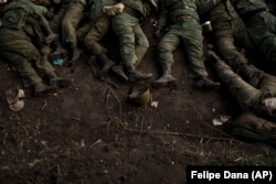 The bodies of 11 Russian soldiers lie on the ground in the village of Vilkhivka, near Kharkiv, Ukraine, on May 9.