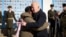 U.S. President Joe Biden (right) embraces his Ukrainian counterpart, Volodymyr Zelenskiy, as they visit the Wall of Remembrance to pay tribute to slain Ukrainian soldiers, in Kyiv on February 20.