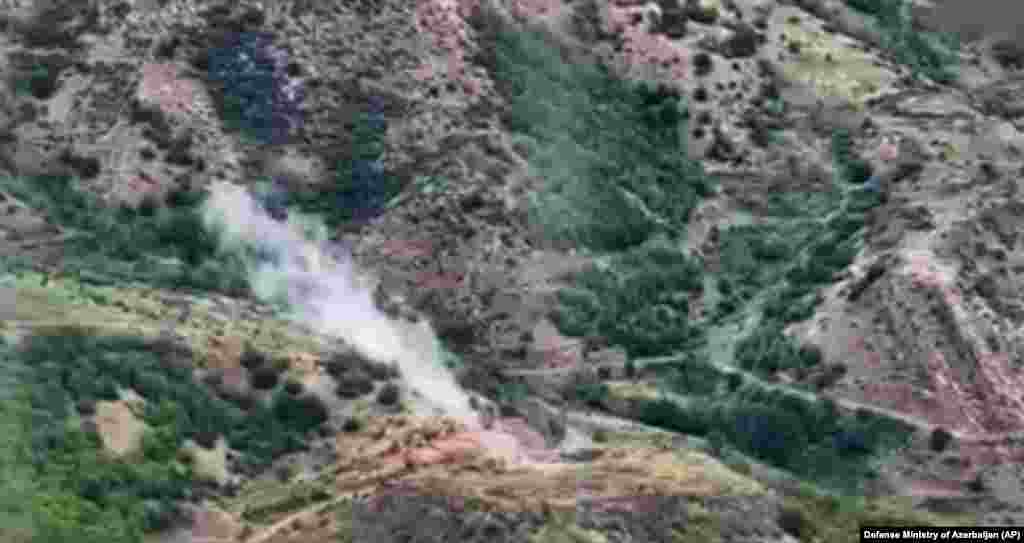 Smoke rises over an area that Azerbaijan claims hosts ethnic Armenian forces&#39; positions in the breakaway territory of Nagorno-Karabakh on September 19. The expected halt in intense fighting in the decades-old Caucasus hot spot comes as international fears of a widening conflict mounted and as the death toll increased in the deadliest military escalation there in nearly three years.