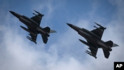 The Ukrainian Air Force's F-16 fighter jets fly in an undisclosed location in Ukraine, Sunday, Aug. 4, 2024.