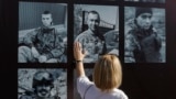 A woman attends a ceremony on Kyiv's Independence Square commemorating soldiers killed in a July 2022 strike that destroyed a building housing Ukrainian prisoners of war in Olenivka, eastern Ukraine. 