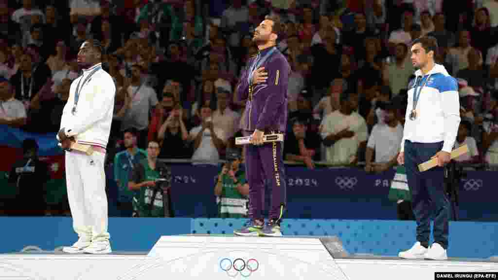 Silver medalist Joan-Benjamin Gaba of France (left), gold medalist Hidayat Heydarov of Azerbaijan, and bronze medalist Adil Osmanov of Moldova pose on the podium after the men&#39;s 73-kilogram final bout of the judo competition on July 29.