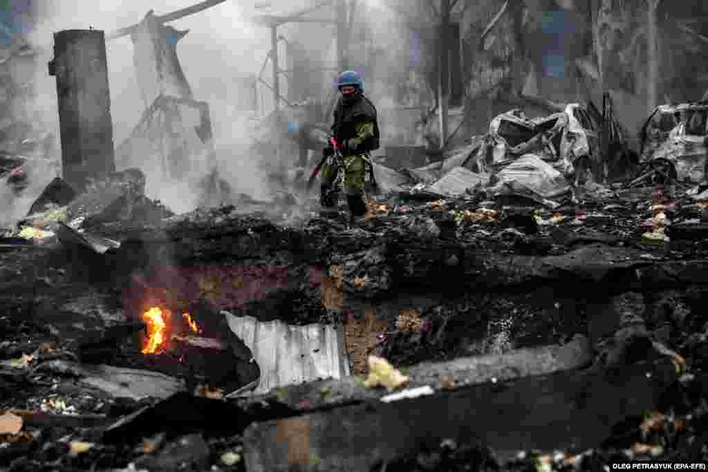 Ukrainian rescue service members work at the site of a Russian missile strike on a residential area of Kyiv on September 21.