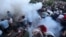 ARMENIA - Demonstrators react to stun grenades fired by law enforcement officers during a protest against Armenian Prime Minister Nikol Pashinian in Yerevan, June 12, 2024. 