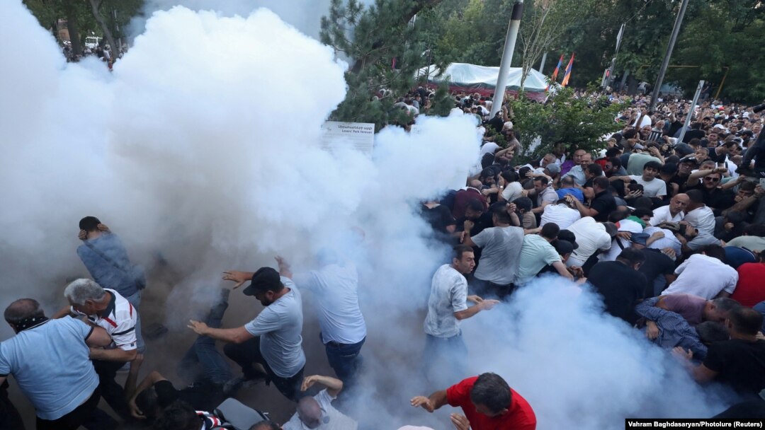 ARMENIA - Demonstrators react to stun grenades fired by law enforcement officers during a protest against Armenian Prime Minister Nikol Pashinian in Yerevan, June 12, 2024.