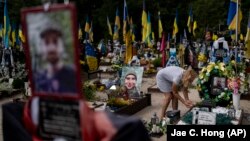 Natalya Zaichenko, 60, tends to the grave of her son, a Ukrainian soldier who was killed in the war against Russia, in Kyiv on August 3.
