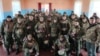 Российский глава Крыма Сергей Аксенов (в центре) с российскими военными, 20 февраля 2023 года