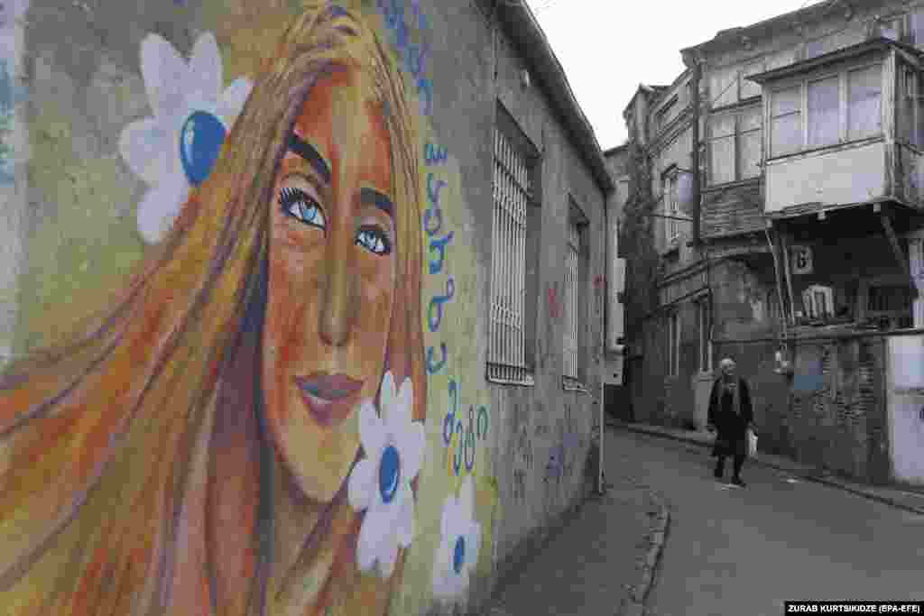 A woman walks in a street of the old town of Tbilisi, Georgia.