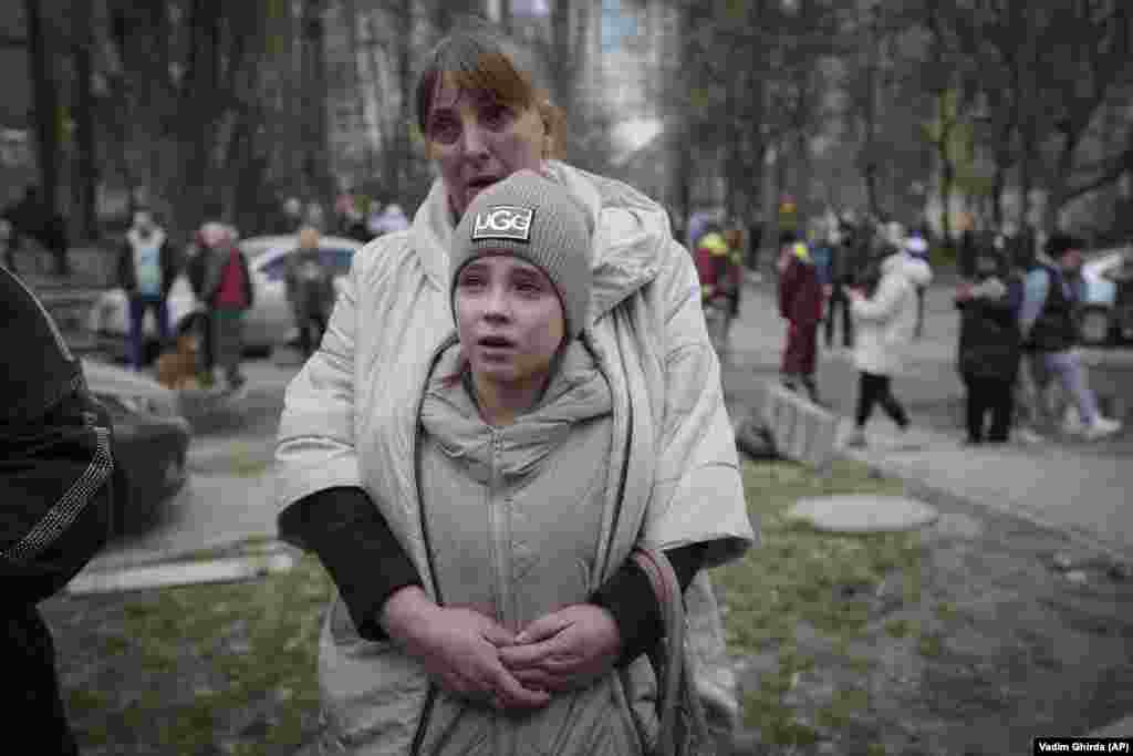 Residents of the Pechersk district stand near an area damaged by a Russian air attack in Kyiv.
