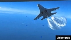 In the 43-second video clip, two Russian Su-27 jets can be seen dumping fuel as they fly close to the MQ-9 Reaper drone.