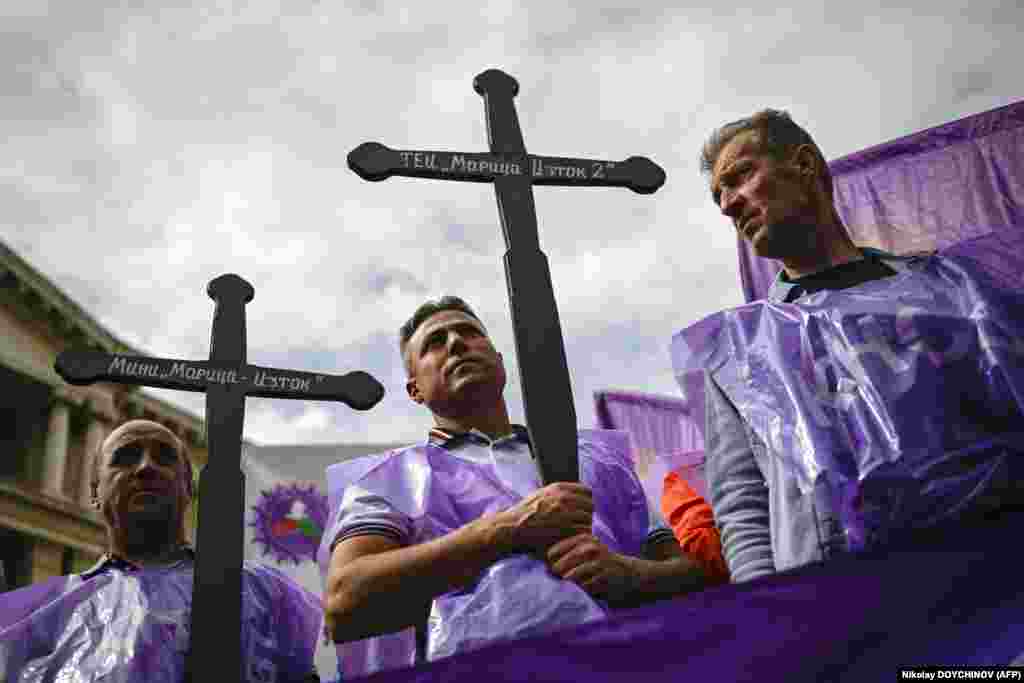 Miners and members of Bulgaria&#39;s trade unions hold wooden crosses during a protest in front of the Bulgarian parliament in Sofia on September 19. A few thousands miners and members of Bulgaria&#39;s trade unions gathered to demand a clear and secure energy future for Bulgaria.