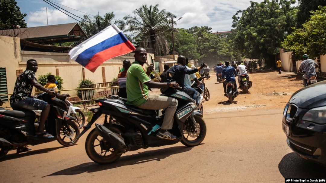 Supporters of a coup in Burkina Faso wave a Russian flag in October 222.