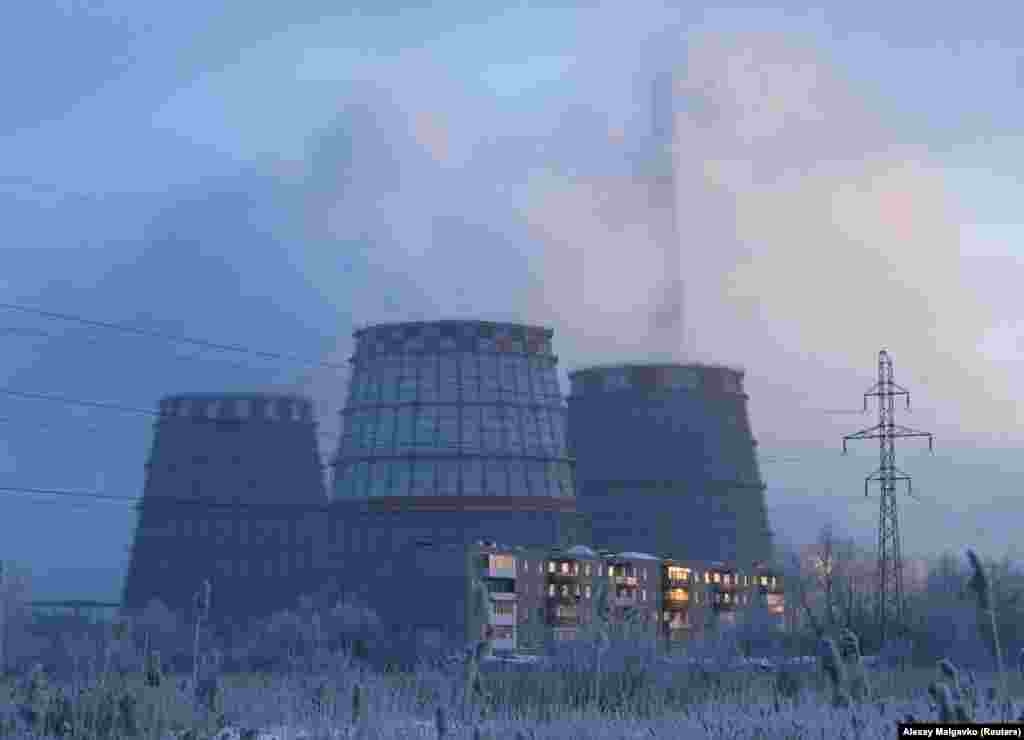 &nbsp;A view of an apartment block next to the chimneys of a thermal power plant in Omsk, Russia.&nbsp;