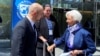 Ukrainian Prime Minister Denys Shmyhal, accompanied by Ukrainian Ambassador to the United States Oksana Markarova (center), talks with European Central Bank President Christine Lagarde near the IMF building in Washington on April 13.