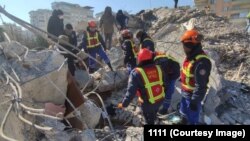 Rescuers search the rubble for survivors following a February 9 earthquake in Turkey.