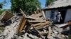 Local resident Lilia Tabala, 75, looks at the ruins of her garage and summer kitchen, destroyed by recent shelling in the town of Horlivka, Donetsk region, Ukraine, on June 5.