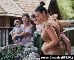 A family from Belgrade sees Muja in his summer enclosure for the first time.