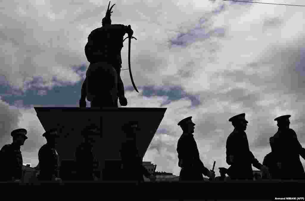 Kosovo soldiers march next to the Scanderbeg statue during the opening ceremony of the military exercise Defender 2023 in Pristina.