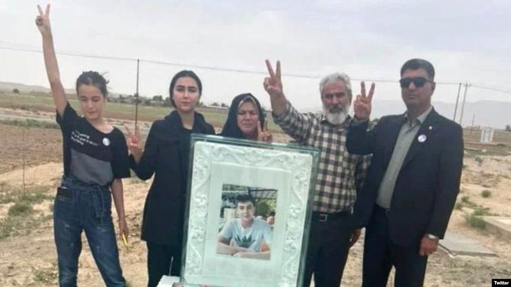 Abolfazl Adinezadeh's family hold a picture of the young man, who was killed during protests in Iran in October 2022. (file photo)