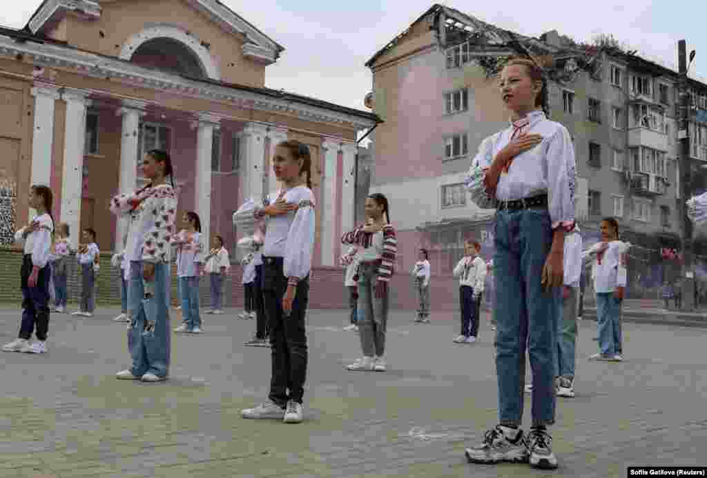 Children in Izyum in Ukraine&#39;s Kharkiv region take part in a celebration marking the first anniversary of the recapturing of their town amid Russia&#39;s invasion on September 10.